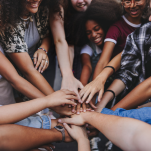Young multicultural people joining hands